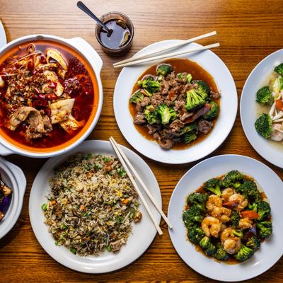 A variety of dishes on a wooden table, top view.