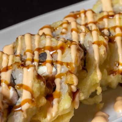 Mika roll, tempura sushi roll with creamy sauce drizzle.