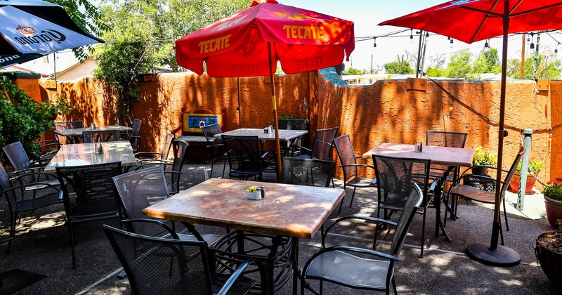 Patio area, tables, chairs and sun umbrellas