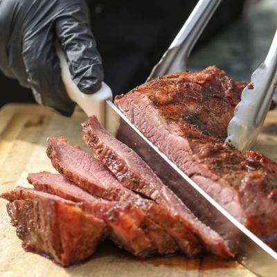 Slicing grilled tri-tip, close up.