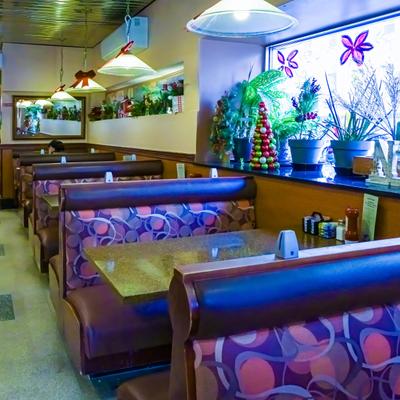 Restaurant's dining room with booth seating and various decorations.