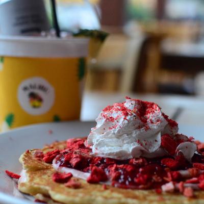 Strawberry cream cheese pancakes, topped with whipped cream.