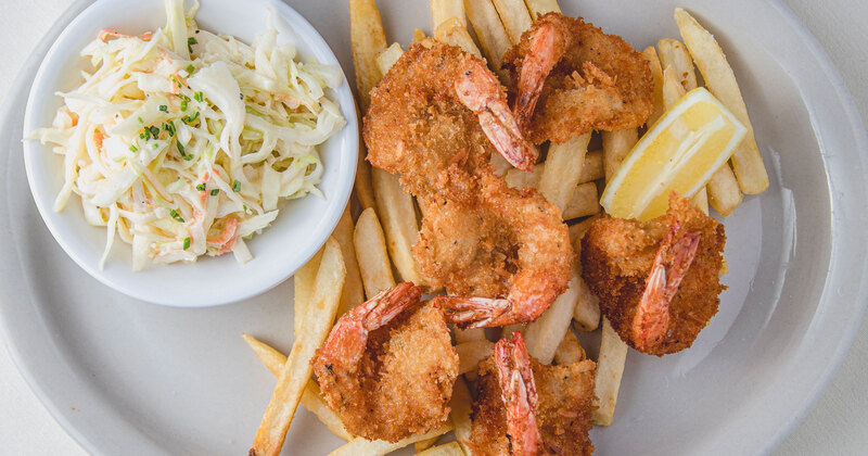 Fried shrimp with french fries and coleslaw, top view