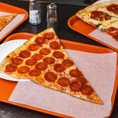 A slice of pepperoni pizza on a tray.