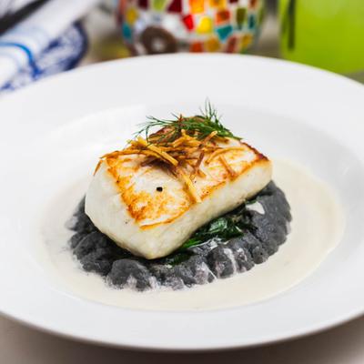 Halibut served over cauliflower puree, sauteed spinach, and beurre blanc sauce.