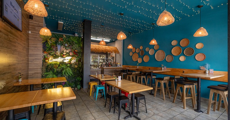 Interior, dining area, regular and high seating tables with chairs, tile flooring