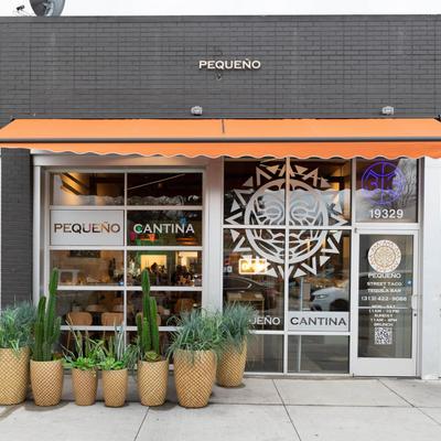 Exterior, entrance area with restaurant logo on the door