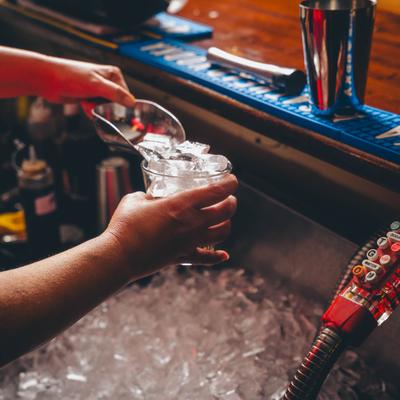 Hands preparing a drink.