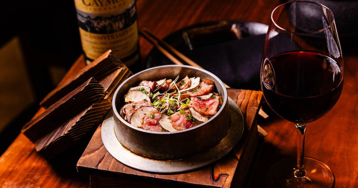 Seared Wagyu beef and truffle hot pot dish paired with red wine