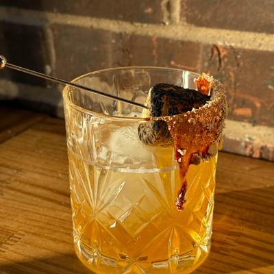 Cocktail with a toasted marshmallow.