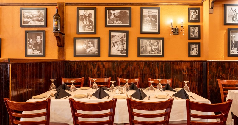 Interior, table set and ready for guests, pictures on the wall