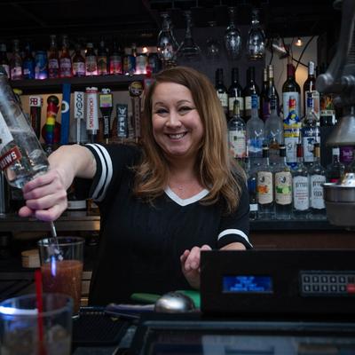 A bartender pouring a drink.