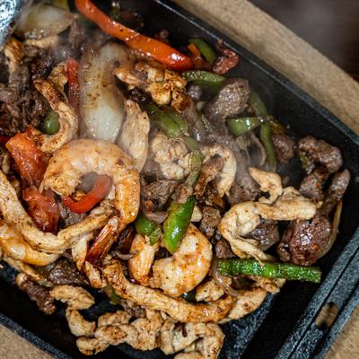 Mixed shrimp, chicken, and steak fajitas.