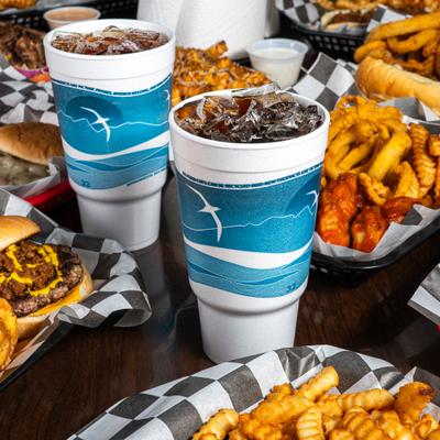 Large drinks, assorted dishes behind.