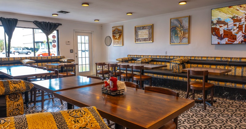 Interior, entrance, dining area, banquette seating with wooden top tables