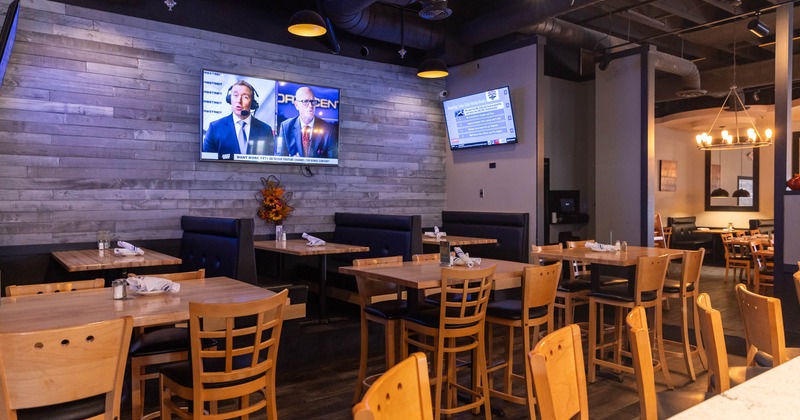 Interior, wooden tables and chairs, booth area in the back