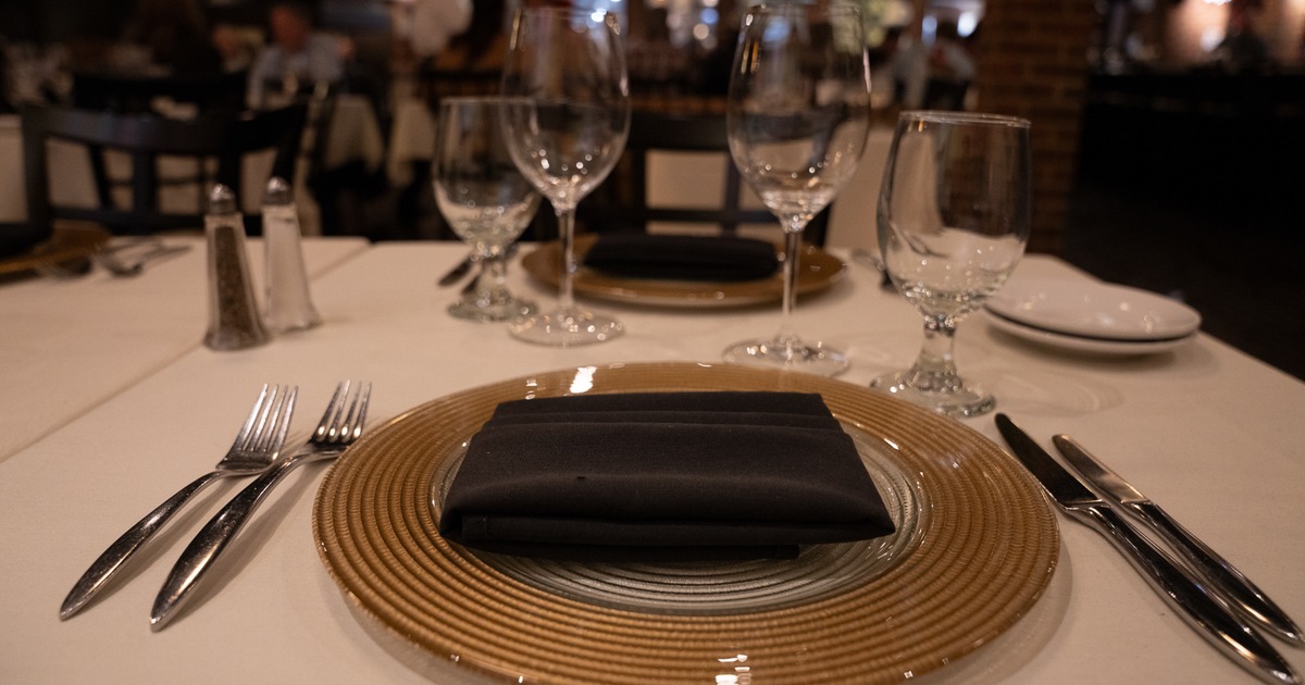 Dinner plate, utensils, napkin, and glasses