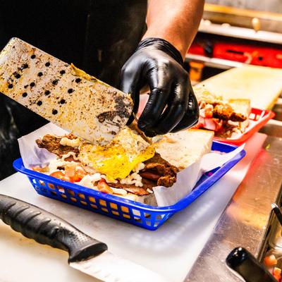 Hands preparing a meal.