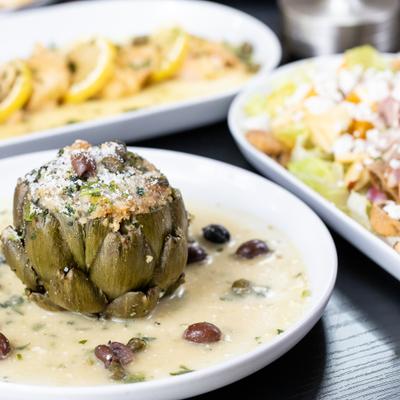 Stuffed Artichoke featuring a mix of breadcrumbs, garlic, cheese, parsley, olives and capers.