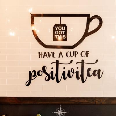 Wall mural with a tea cup illustration and text.