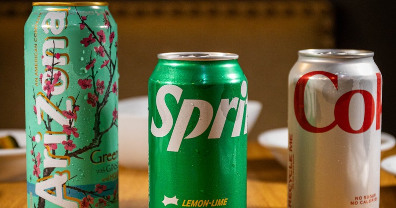 Various canned drinks served on a wooden table