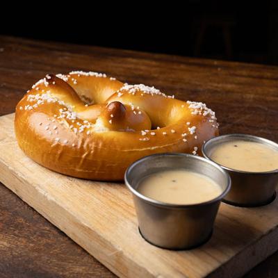 A served Pretzel with dips.