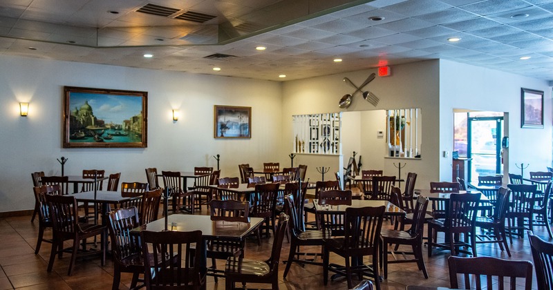 Dining tables and chairs, paintings on walls