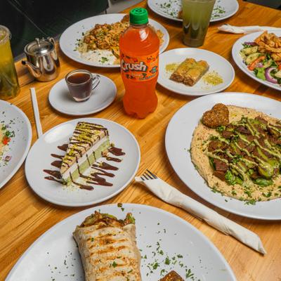 Various menu items served on the table with drinks and condiments.
