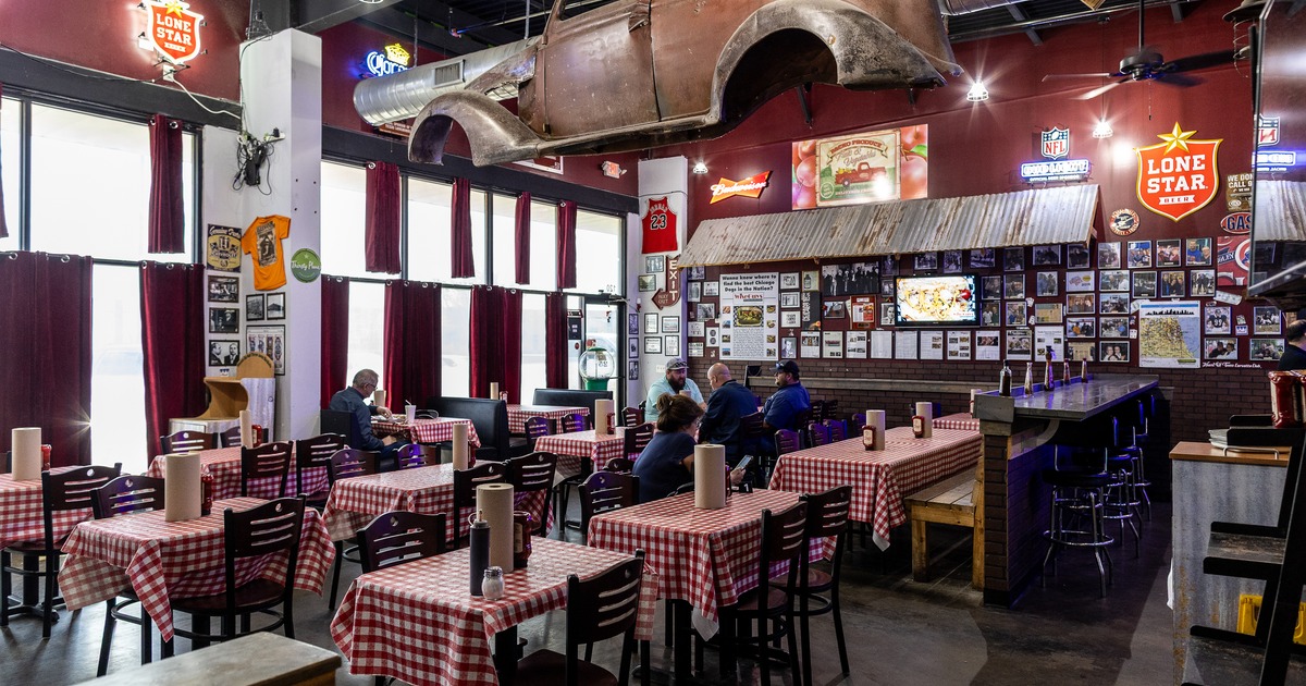 Diner area, tables, chairs, car body hanging above
