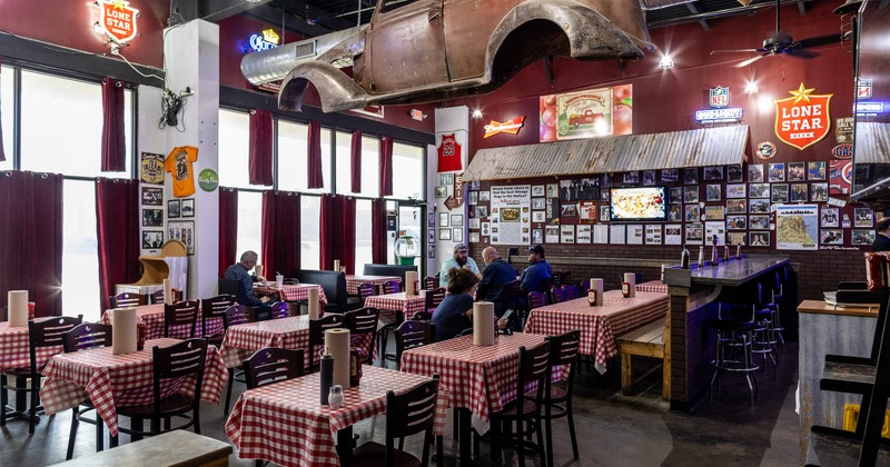 Diner area, tables, chairs, car body hanging above