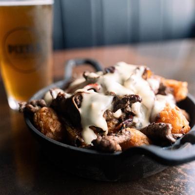 Tater tots loaded with rib eye, peppers, onions, and cheese sauce.