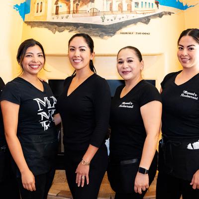 Restaurant staff in uniforms.