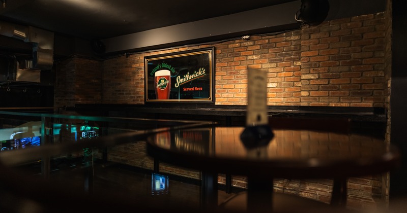 Interior, gallery, beer sign on the wall behind, view over table