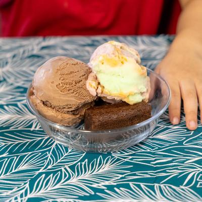 Ice cream on the table and a guest's hand.