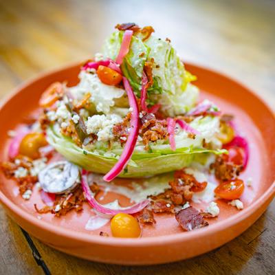 Wedge salad with various topings.