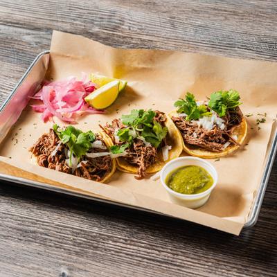Mini street tacos  served with red onion, lime and green salsa.