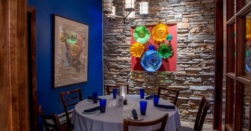 Set up dining table with framed pictures on the wall