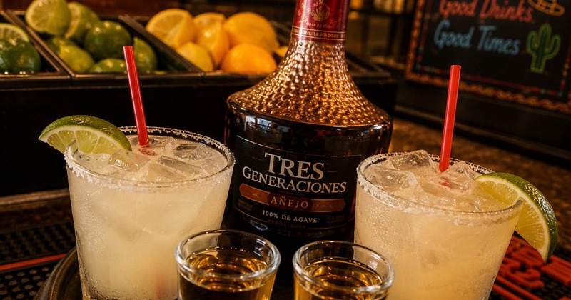 Bottle and shots of tequila, and Margarita cocktails