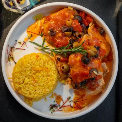 Slow-braised garlic and saffron-infused chicken thighs, served with vegetable rice.