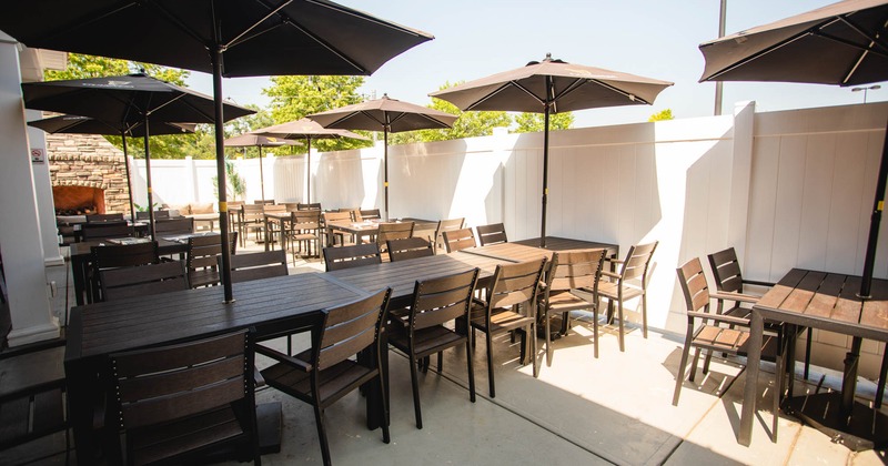 Exterior seating area with chairs, tables and parasols