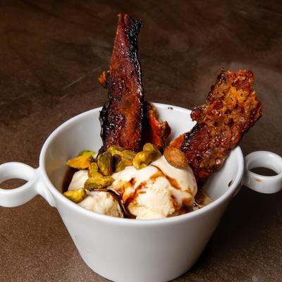 Vanilla ice cream with candied bacon, pistachios, and chili paste oil.