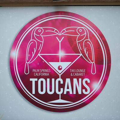 Toucans Tiki Lounge and Cabaret Palm Springs sign with toucan illustration.