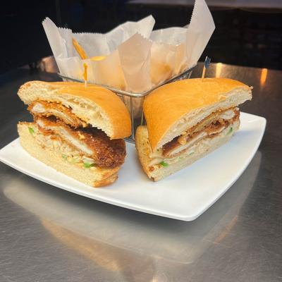 Fried chicken cutlet sandwich served with french fries.