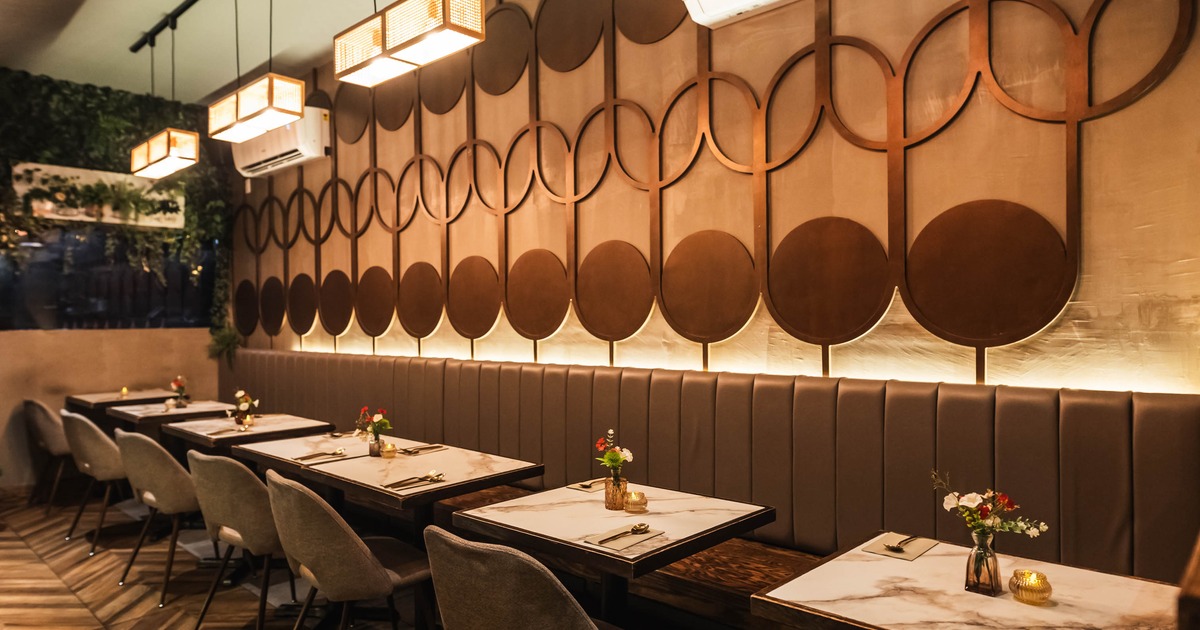 Cozy restaurant interior featuring wooden walls and a unique circular wall design