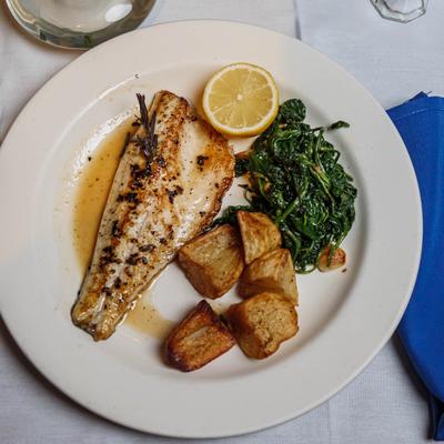 Mediterranean sea bass filet, lemon,  roasted potato and sauteed spinach