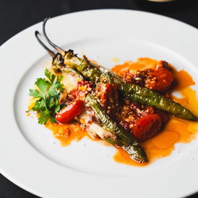 Long green chile peppers with cherry tomatoes and cheese.
