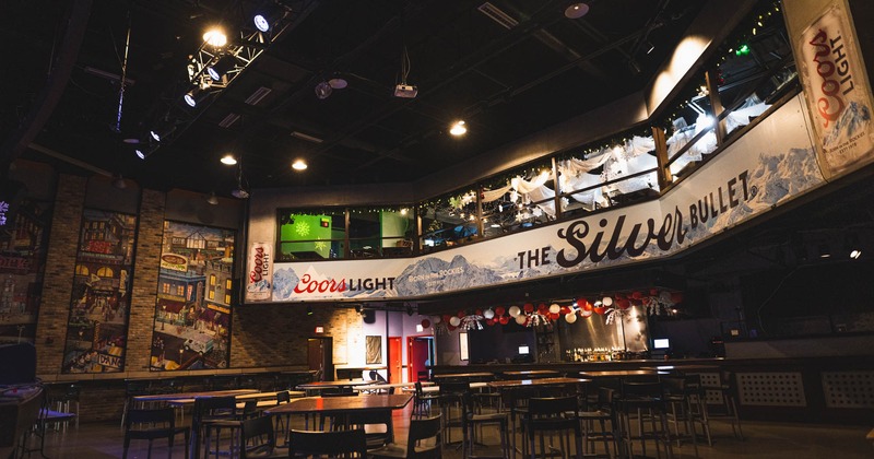 Interior, concert hall, high seating tables with stools, murals, ''Coors Light'' banners