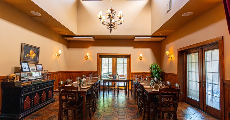 Interior, dining area, ''U'' shape set up tables with wooden chairs, balcony doors