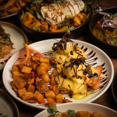 The Brick Benedict with homefries, alongside other dishes.