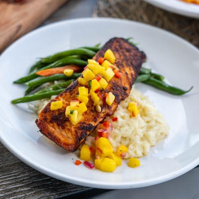 Blackened salmon, served, top view.